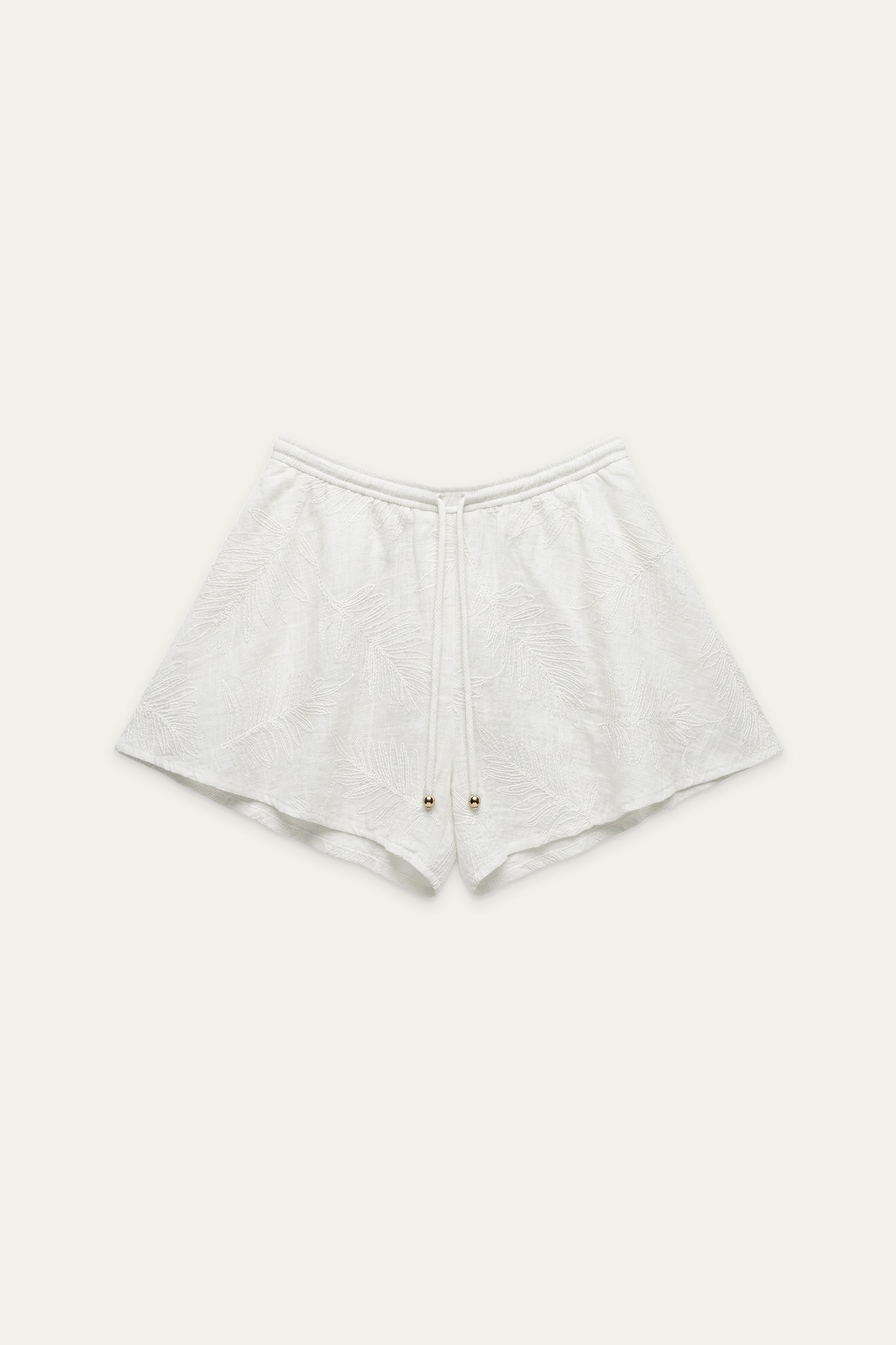 Shorts in Off-White mit elastischem Bund, Kordelzug und eingewebtem Blattmuster, flach liegend